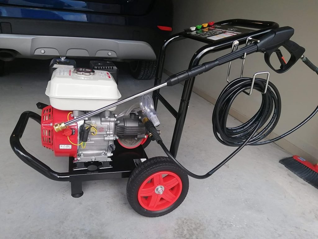 Cliente che lava l'auto con detergente e idropulitrice